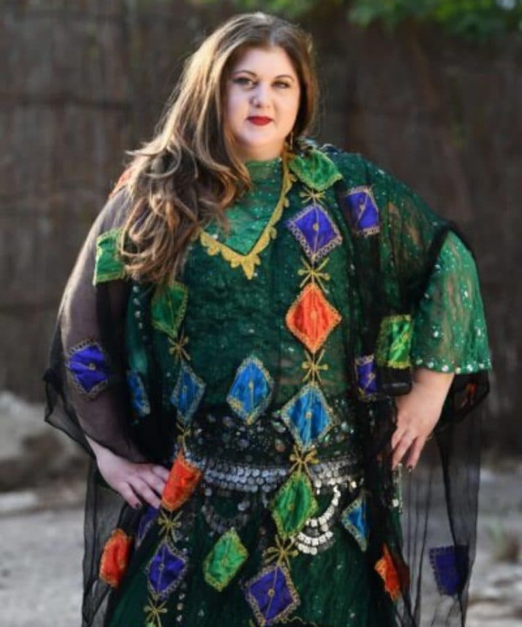 Zaira, founder of Melbourne Belly Dancing, in a jeweled green kaftan