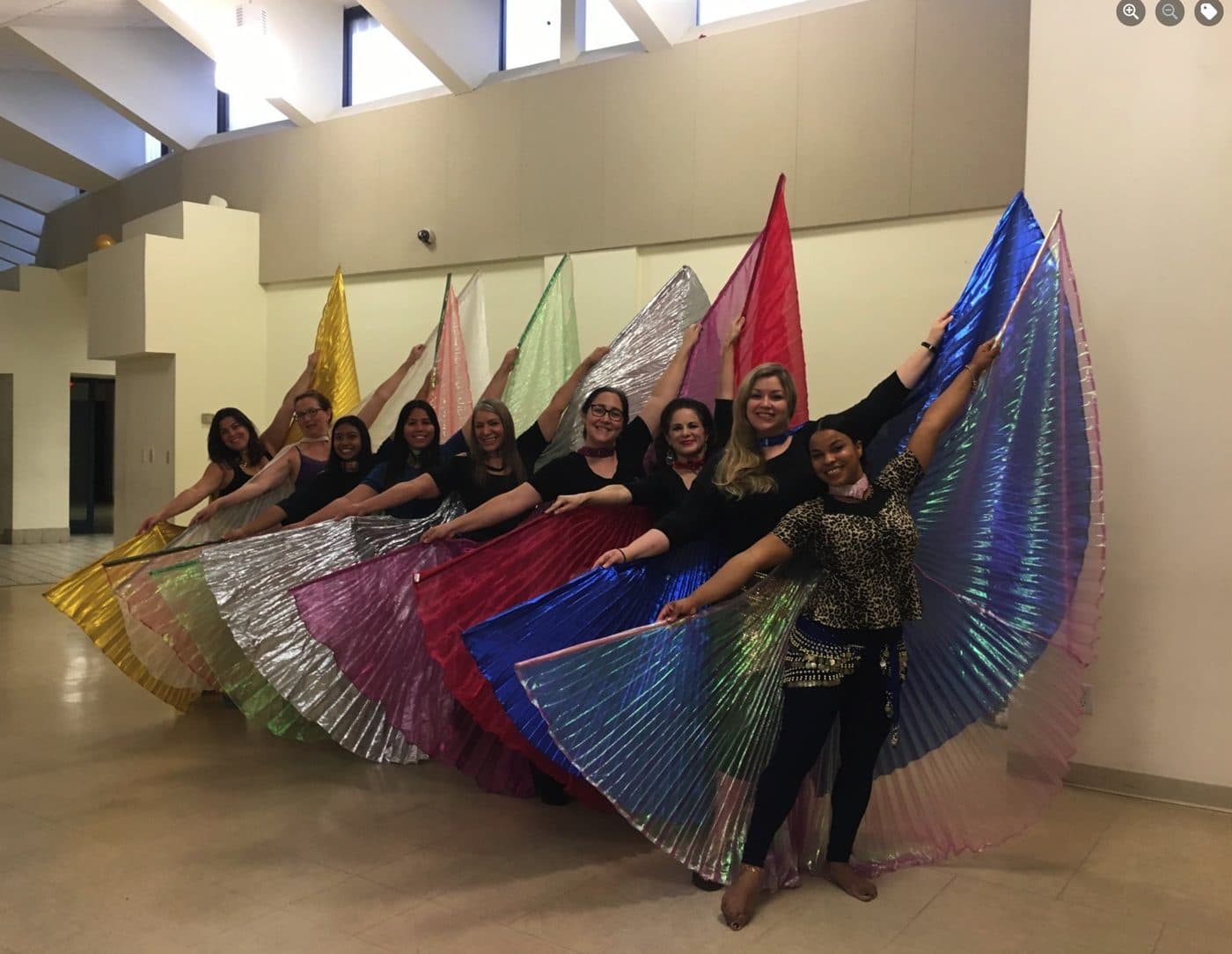 Students spreading rainbow Isis wings in the studio